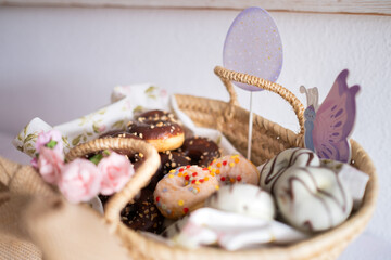 Detail of a basket with mini Easter-colored donuts on an Easter candy table. Typical Easter sweets...