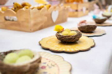 Easter candy table.. Typical Easter sweets on a festive celebration table. There are Easter eggs from the tradition of the Easter bunny and chocolate eggs, cakes and bunnies