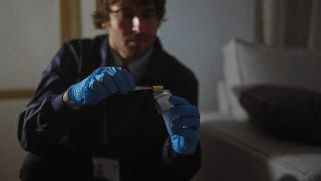 A focused man analyzes evidence indoors at a crime scene investigation.