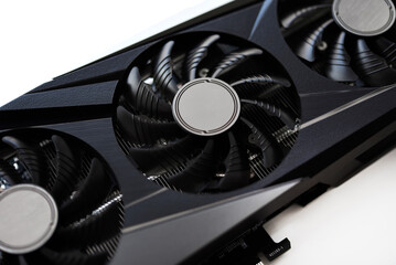 A black and white video card on a white background. Fans and the graphics card case. Computer accessories.