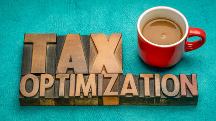 tax optimization, financial concept in vintage letterpress wood type with coffee, business and tax planning