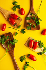 Flat lay composition with tomatoes and parsley on yellow background. - 778400447