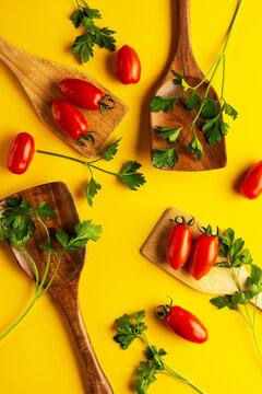 Flat lay composition with tomatoes and parsley on yellow background.