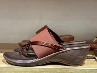 Trendy ladies sandals slippers on shelf in shop