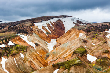 Colorful slopes of the rhyolite mountains with patches of snow. Awesome Icelandic landscape....