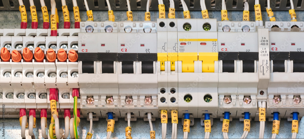 Poster a bunch of wires are connected to a box with yellow and white markings