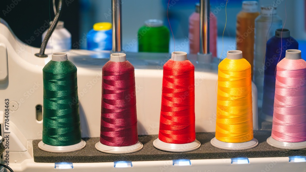 Aufkleber three different colored yarns are displayed on a machine. the machine is used to create various type