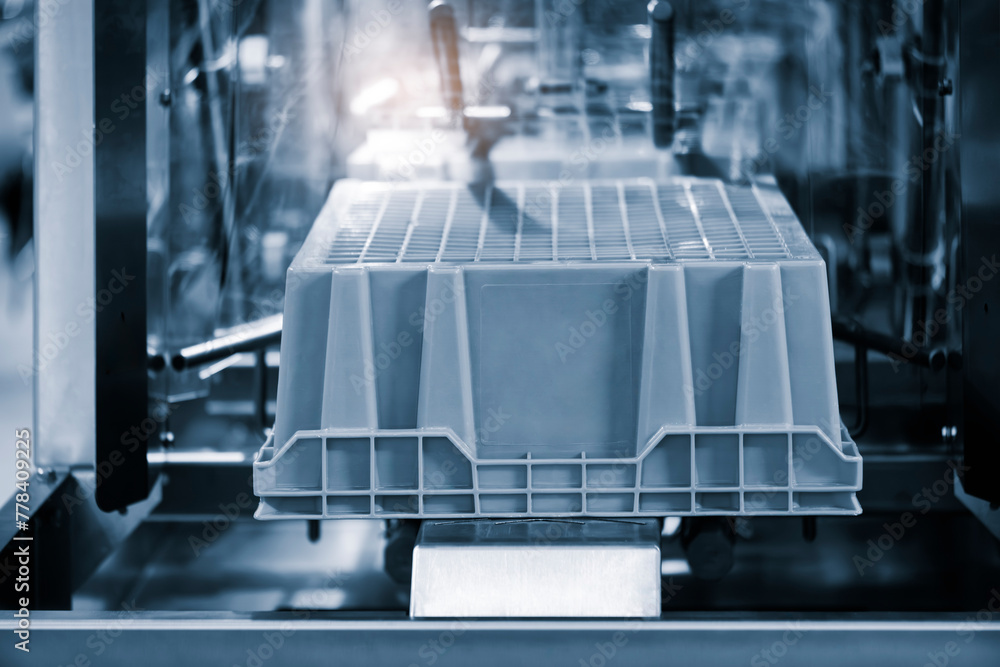 Poster a machine is making a container. the container is blue and white