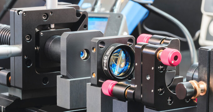 Experiment with laser device in optical laboratory. Experiment in optic lab with laser device.