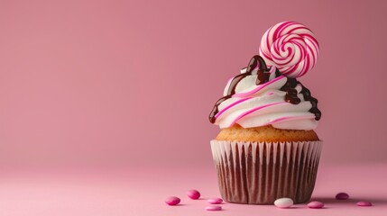 Close-up muffin decoration with white cream and pink lollipop on a pink background, a birthday concept. - obrazy, fototapety, plakaty