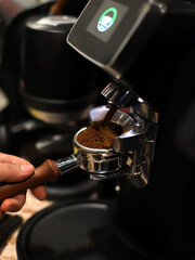 expert barista preparing coffee to make an espresso
