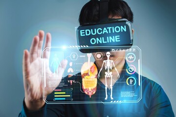 A man is wearing a virtual reality headset and is interacting with a 3D image of a skeleton. The image is titled "Education Online" and he is related to a virtual learning environment