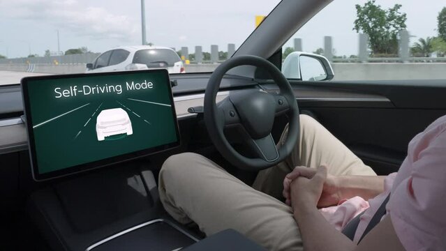 Self driving car or autonomous vehicle travel on speed highway with driverless system and autopilot mode allowing man driver relax and focus on smartphone without compromising safety. Fastidious