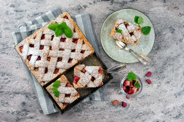 Traditional rhubarb sheet cake with spelt flour served as top view on a Nordic Design plate