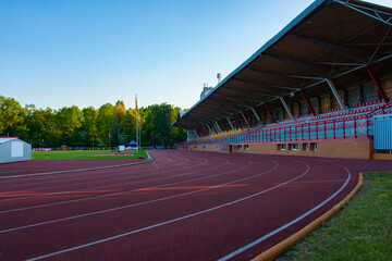 Sports stadium, athletics treadmill for runners at an outdoor stadium, stands for fans, Poland, Bialystok - 778435890
