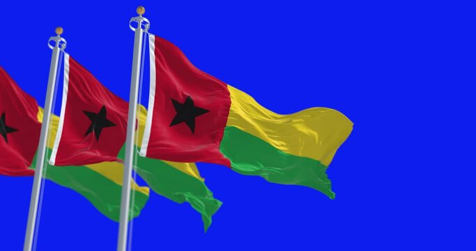 National flags of Guinea-Bissau waving isolated on blue background