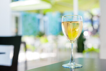 Glass of white wine on outdoor cafe table for brunch
