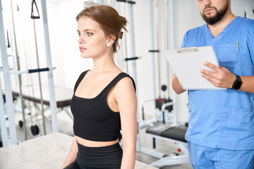 Fototapeta premium Kinesiologist interviews a young woman