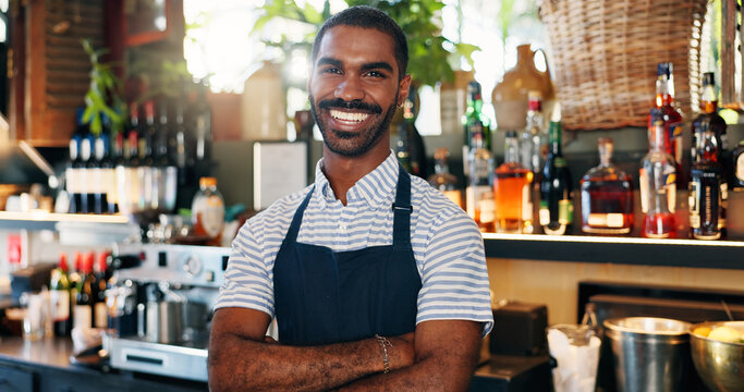 Welcome, coffee shop and confident portrait of man at bar with smile, waiter or manager at restaurant startup. Bistro, service barman and happy small business owner at cafe counter with arms crossed.