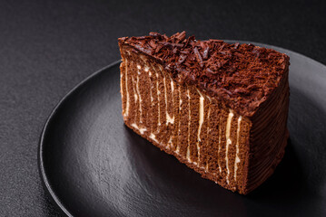 Delicious fresh cheesecake cake or snickers with cream and nuts on a ceramic plate