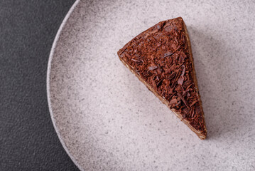 Delicious fresh cheesecake cake or snickers with cream and nuts on a ceramic plate
