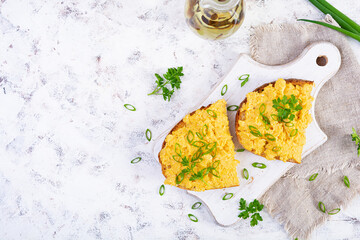 Scrambled eggs with herbs and toasts. Delicious breakfast with eggs and herbs. Top view