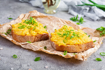 Scrambled eggs with herbs and toasts. Delicious breakfast with eggs and herbs
