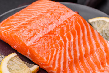 Fresh raw salmon steak with spices and herbs prepared for grilled baking