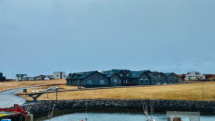 Islamic landscapes, stylish black building in Scandinavian style on the shore of the bay, high quality photo.