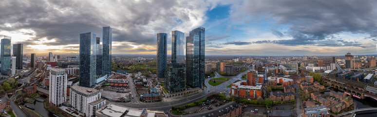 Fototapeta premium The Sunrises over Deansgate Square, a residential skyscraper cluster on the southern edge of Manchester City Centre, UK They are called, North, West, South ,East, The Blade, Beetham Tower and Three60.