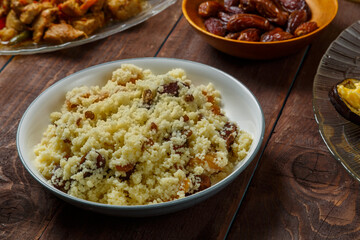 Couscous with dried fruits and nuts on the festive table. Horizontal