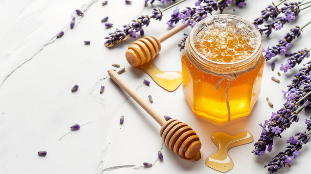 Open honey jar with dipper and lavender sprigs on a white surface.