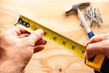 Carpenter with measuring tape