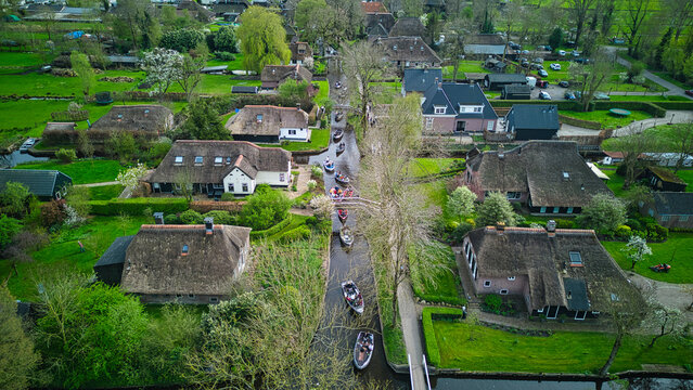 Canals full of tourists on boats in Giethoorn, Netherlands on a busy day