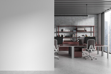 Gray and maroon open space office interior with blank wall