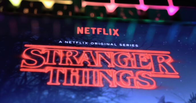 Viersen, Germany - April 3. 2024: Netflix series Stranger things cover poster on smartphone screen on computer keyboard