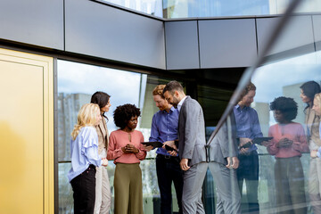 Business Professionals Engaging in a Strategy Discussion Outside a Modern Office Building