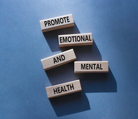 Health symbol. Wooden blocks with words Promote Emotional and Mental Health. Beautiful grey background with. Health concept. Copy space.