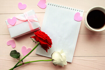 Love composition - coffee cup, gift box and red rose on pink background, top view. Valentines Day greeting card