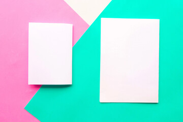 Two white mockup blanks on geometric green, pink and white background. Copy space for the text....