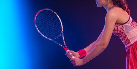 Close-up photo of Tennis player woman with racket on tournament. Girl athlete with racket on open court with neon colors. Download a high quality photo for design of a sports app or tour events. - 778500257
