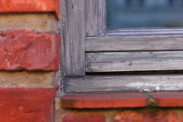 Wooden window frame and red bricks