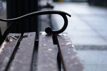 A raindrops on a brown bench
