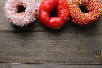 Donuts on a gray background. Three glazed donuts cakes in glaze on a gray background with space for copy space recipe text. Donut Day