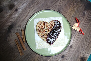 heart shaped chocolate and frosting ginger cake on wooden table