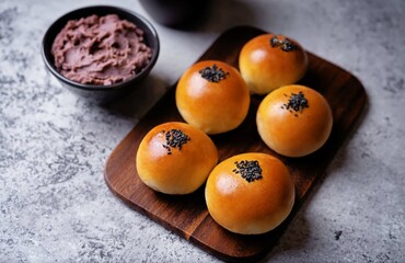 Red bean paste buns with black sesame seeds sprinkles