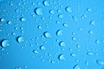 Natural blue water drops on a blue background