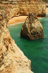 Natural caves, turquoise sea water on coast of Portugal in Algarve region, summer beach concept