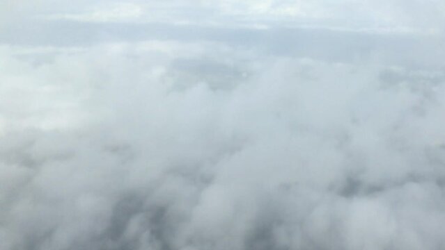 Aerial view of going through the clouds and looking down on the world below
