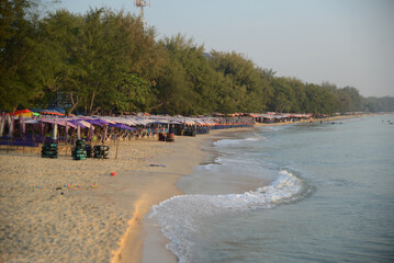 Cha-am beach there are beach deck chairs and large umbrellas available to tourists. Located at Phetchaburi Province in Thailand.